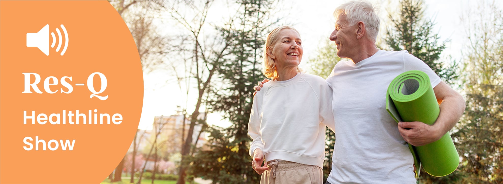 An older couple walks to a yoga session outside.