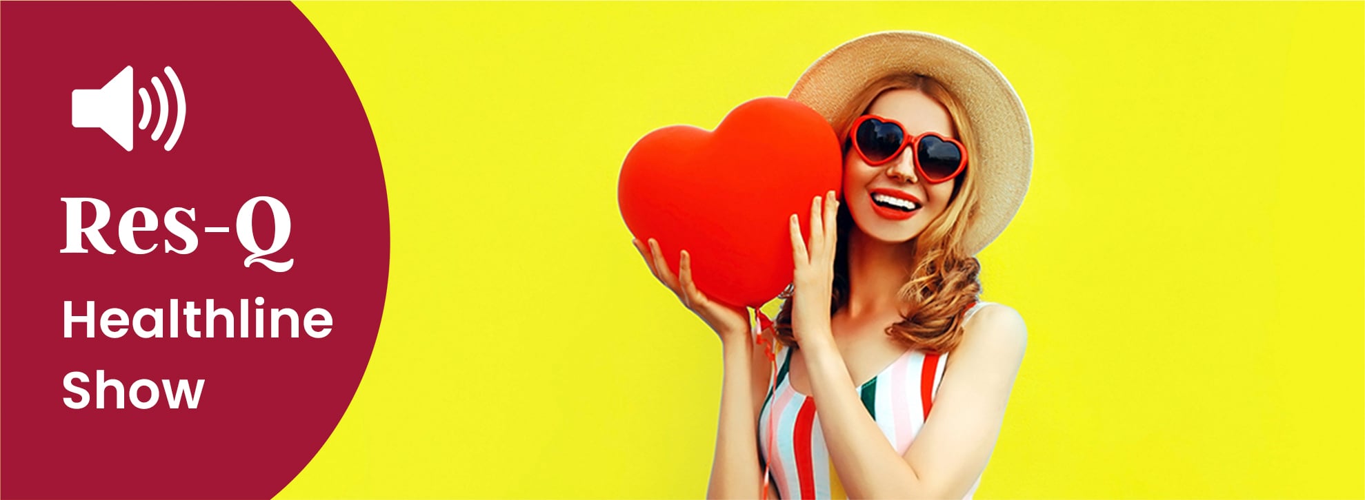 Young woman in a bathing suit holding a balloon heart.