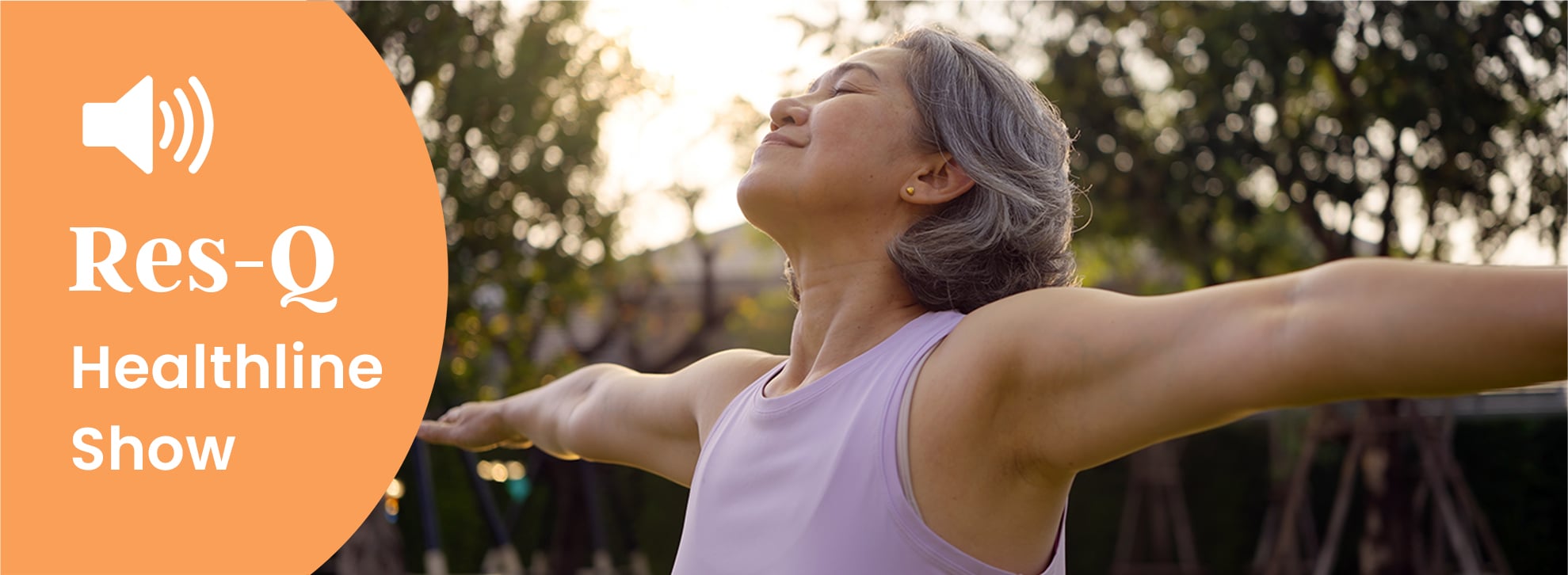 A middle-aged Asian woman does yoga outside in the sun