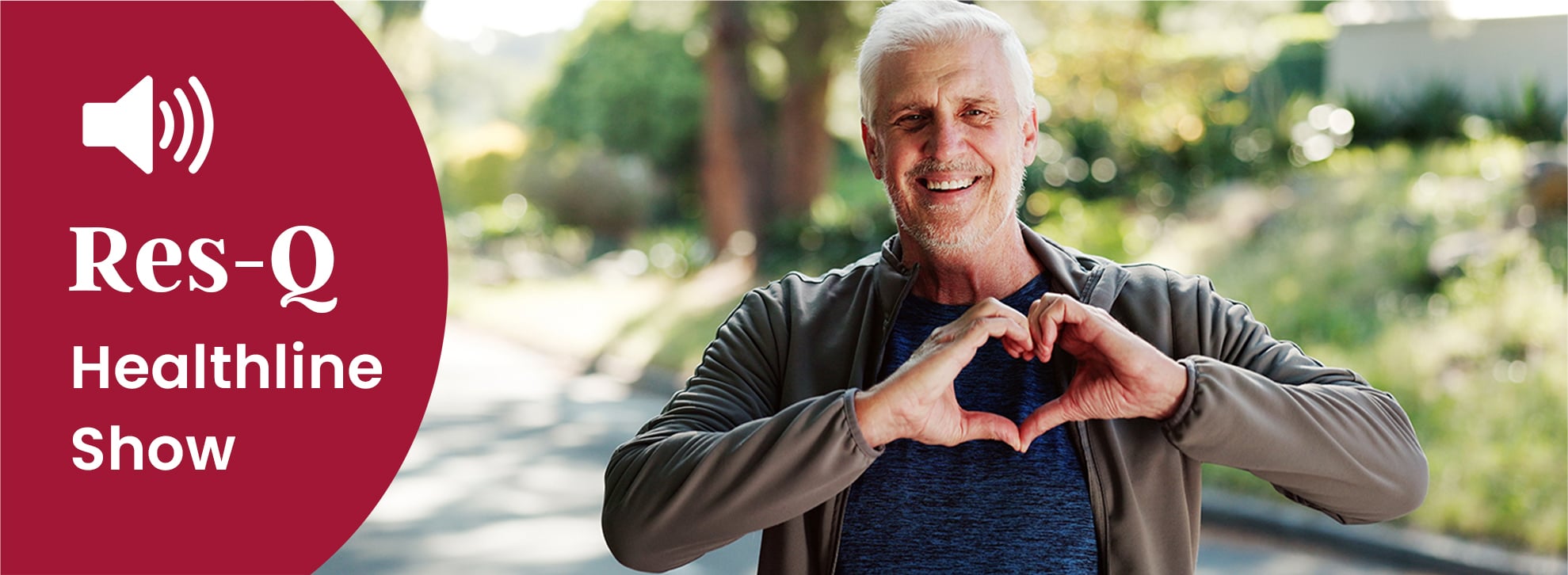 A middle-aged man makes a heart symbol with his hands