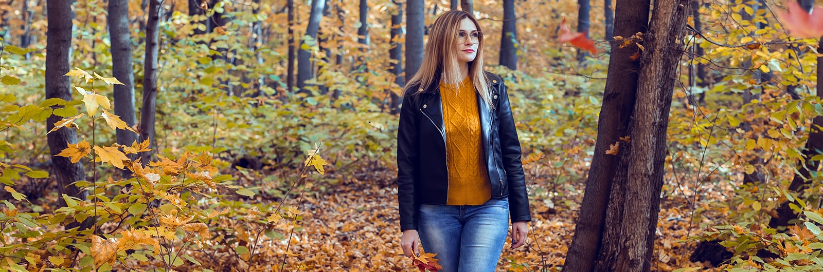 Women walking through autumn trees