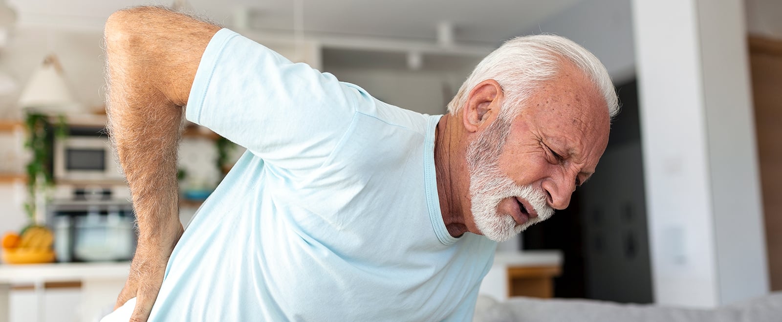 Senior elderly man touching his back, suffering from backpain, stenosis