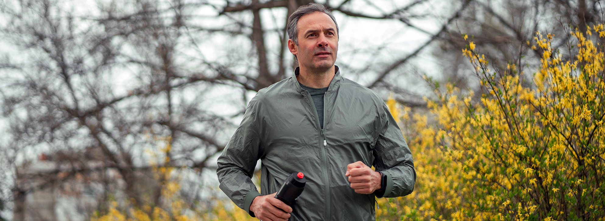 Middle-aged man jogging in the park